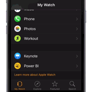 Photograph shows an iPhone with the My Watch app open and the Power B I icon visible.