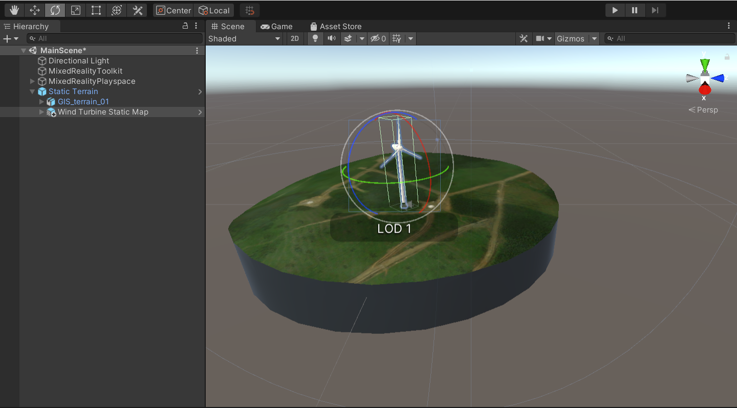 Screenshot of the Unity scene window with the main scene running and the wind turbine static map child object and rotate tool highlighted.