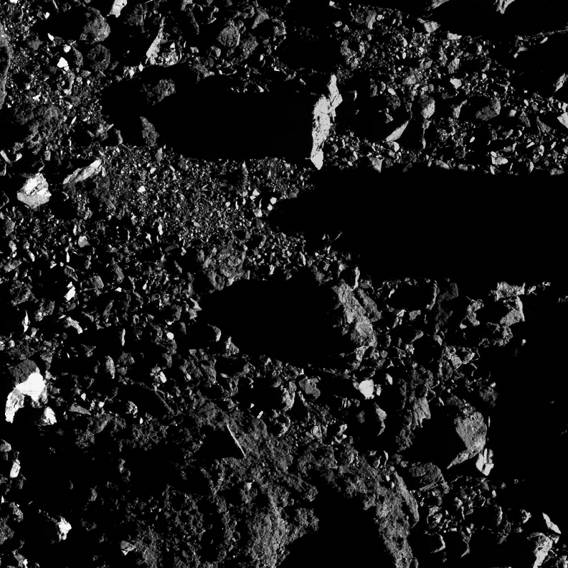 Photo of the surface of an asteroid and patches of fine-grain regolith.
