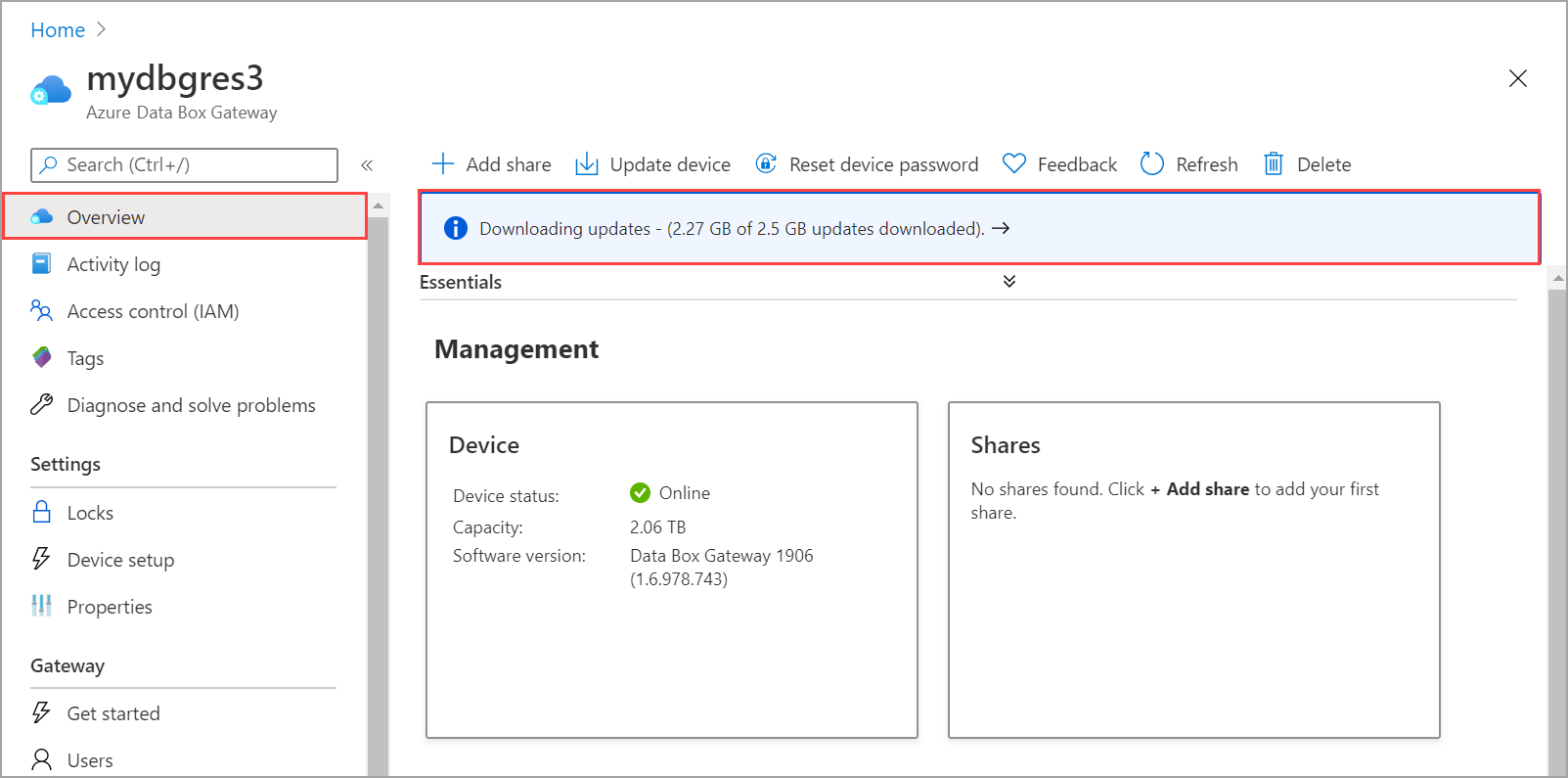 Screenshot of the Azure Data Box Gateway Home page with the Overview option and the Downloading updates notification banner called out.